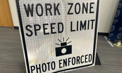 Work zone speed limit sign with camera icon and 'Photo Enforced' text.