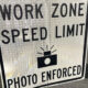 Work zone speed limit sign with camera icon and 'Photo Enforced' text.