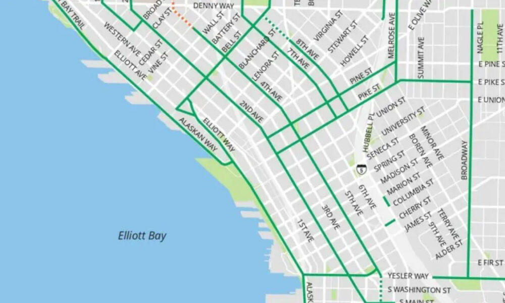 Section of a Seattle street map showing bold green transit routes along the waterfront near Elliott Bay