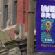 Purple street banner reading 'WE ARE' with the FIFA World Cup trophy and the word 'SEATTLE' at the bottom, hung on a lamppost.