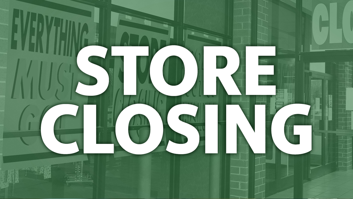 Storefront with a large white 'STORE CLOSING' message across glass doors, tinted green.