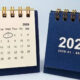 Two mini desk calendars for 2026: left page shows July with the 1 circled, right page shows a bold 2026 and the date range 2026.01–2026.12.