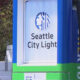 Seattle City Light logo on a blue and green utility box outdoors