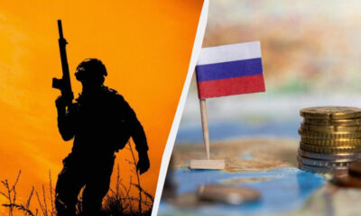 Silhouette of a soldier with a rifle against an orange sky on the left, with a small Russian flag and a stack of coins on a map on the right, split by a diagonal line.