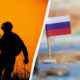 Silhouette of a soldier with a rifle against an orange sky on the left, with a small Russian flag and a stack of coins on a map on the right, split by a diagonal line.