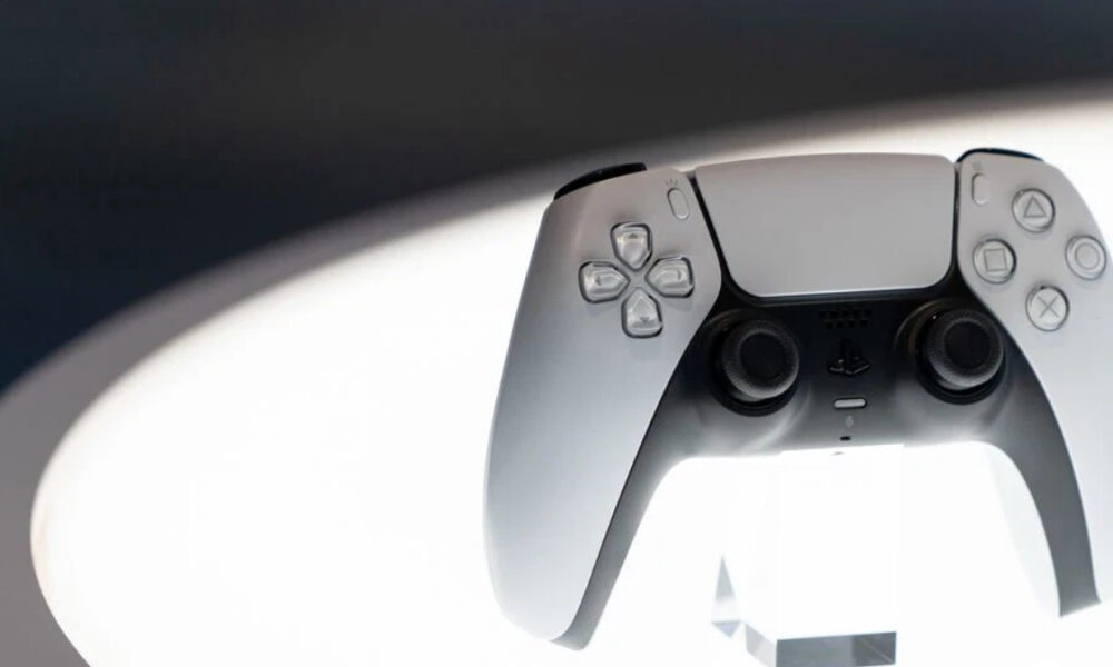 White PlayStation 5 DualSense wireless controller facing forward, with joysticks and buttons visible against a soft background.