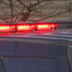 Police vehicle with red emergency lights flashing on its roof
