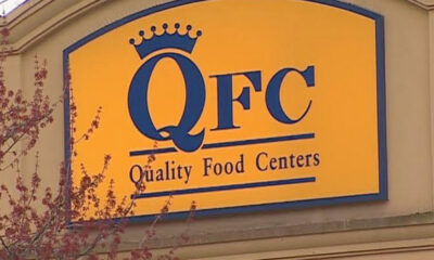 Yellow sign with blue crown logo reading 'QFC Quality Food Centers'.