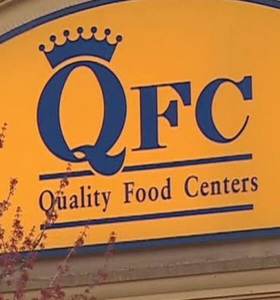 Yellow sign with blue crown logo reading 'QFC Quality Food Centers'.
