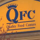 Yellow sign with blue crown logo reading 'QFC Quality Food Centers'.