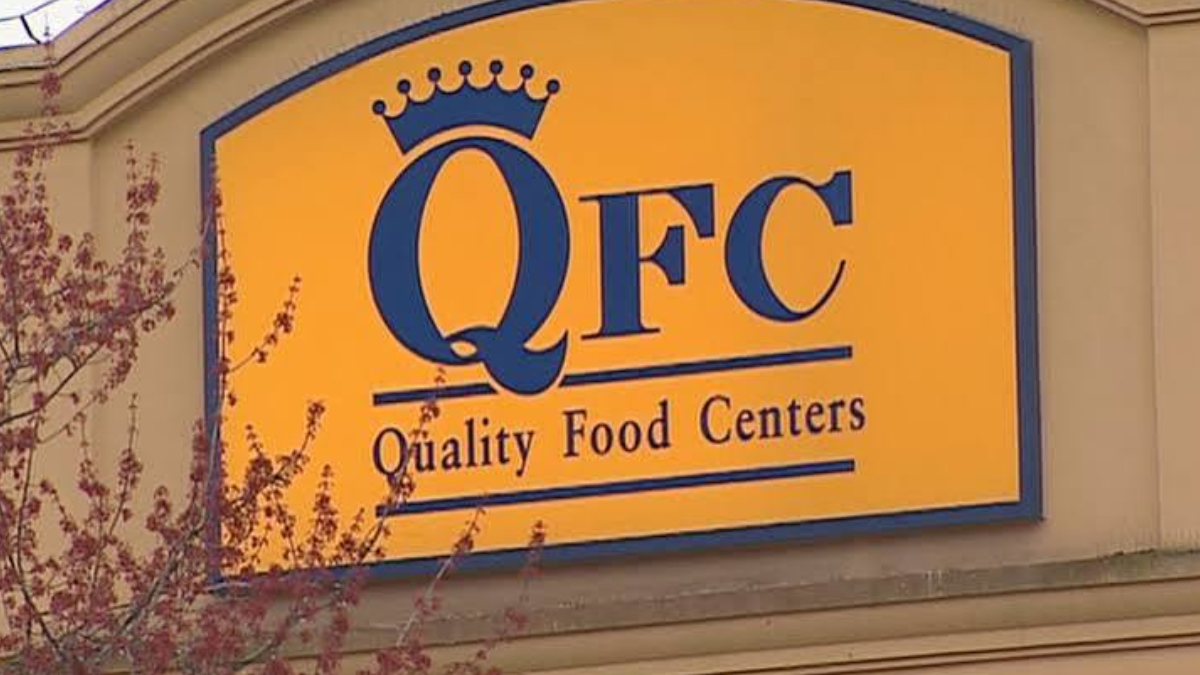 Yellow sign with blue crown logo reading 'QFC Quality Food Centers'.