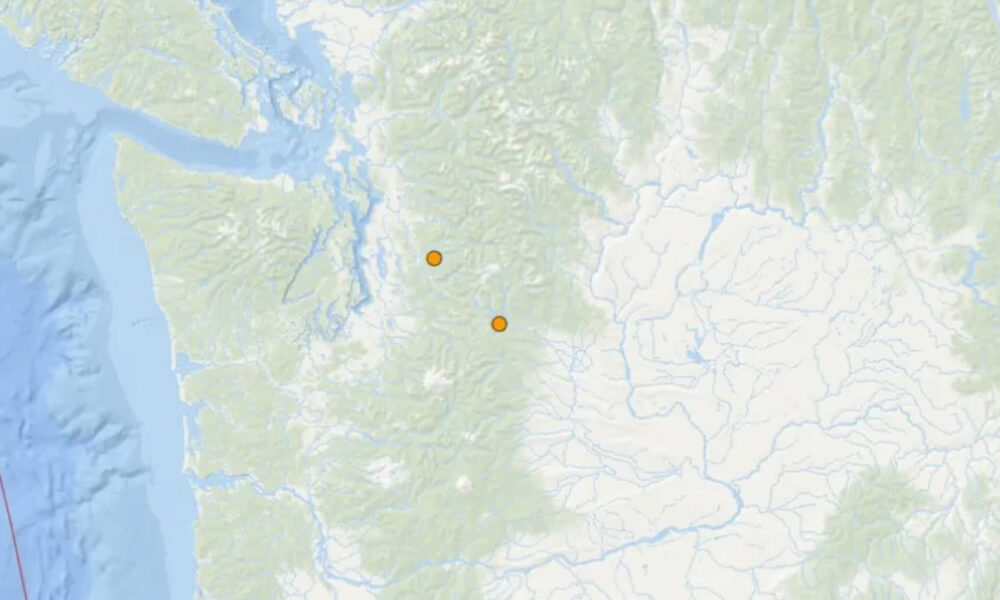 Map showing two orange location markers inland on a mountainous region of a coastal map.