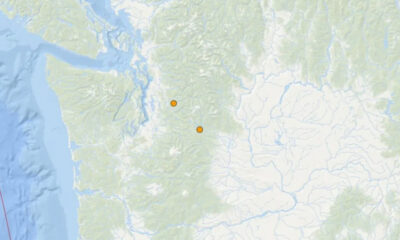Map showing two orange location markers inland on a mountainous region of a coastal map.