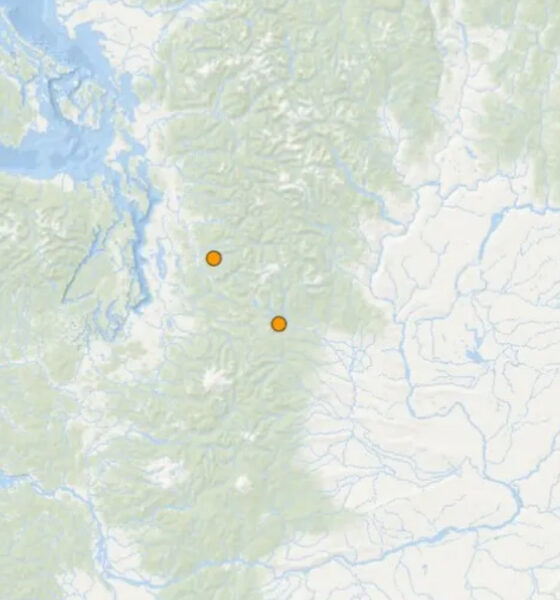Map showing two orange location markers inland on a mountainous region of a coastal map.