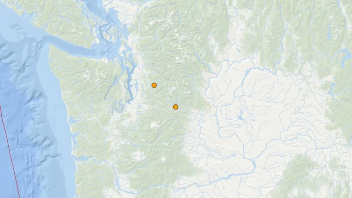 Map showing two orange location markers inland on a mountainous region of a coastal map.