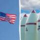 Split scene: left shows an American flag fluttering on a flagpole under a clear blue sky; right shows tall nuclear missiles with red bands and radiation symbols against a cloudy sky.