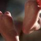 Close-up of a newborn baby's tiny feet resting together.