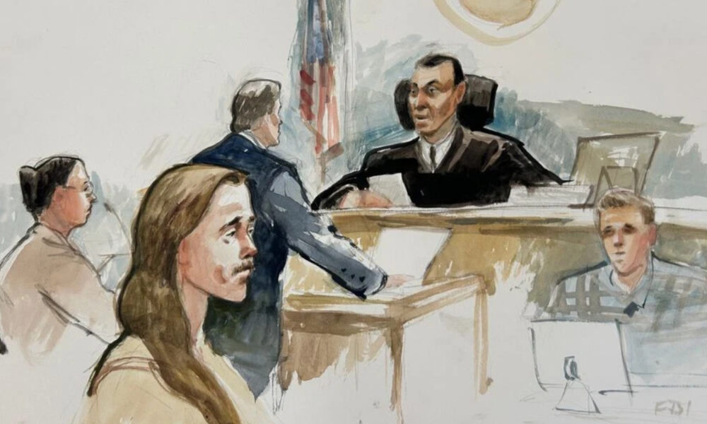A courtroom sketch showing a judge at the bench, a defendant seated, and several people seated or standing nearby in a court setting.