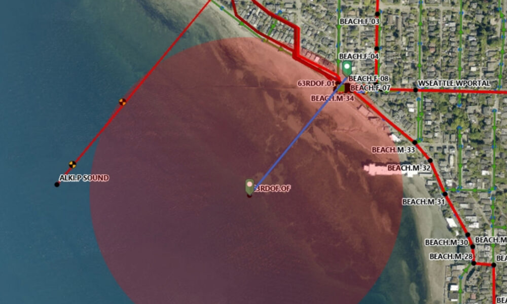 Coastal hazard map showing a red offshore circular zone near Beach neighborhoods and Alki Point, with a blue reference line and labeled streets on shore.