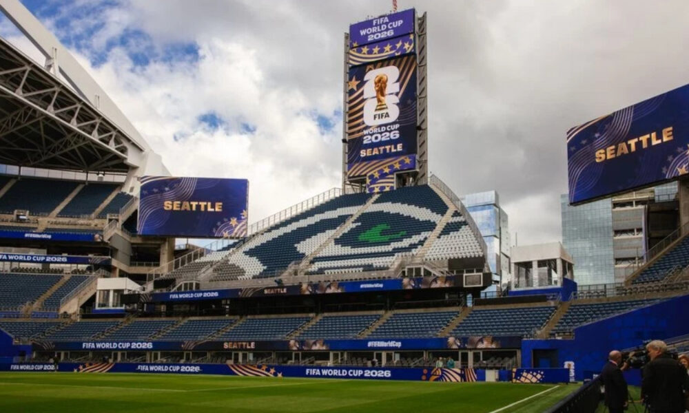 Seattle FIFA World Cup 2026 stadium with large screens displaying 'Seattle' and a green field in the foreground