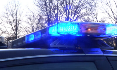 Police car with blue flashing lights on top at dusk