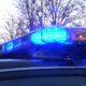 Police car with blue flashing lights on top at dusk