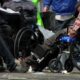 Group of people in wheelchairs gathered on a street with litter, a news logo visible in the corner (FOX Local).