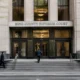Front of King County Superior Court building with double doors, stone facade, and people walking up the steps, under a large sign.