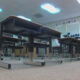 Low-angle view of an empty classroom with rows of desks and stacked chairs along the back wall.
