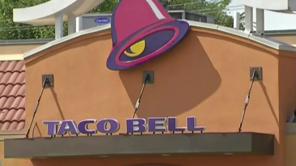 Taco Bell restaurant exterior with a purple bell-shaped logo on an orange facade.