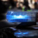 Blue and red police car emergency light bar on the roof, flashing against a dark background.