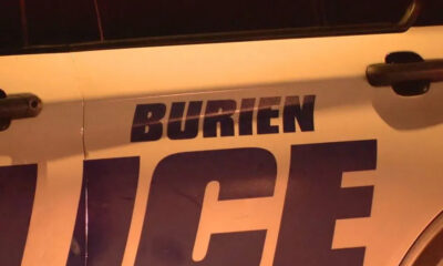 Close-up of a police car door with large 'POLICE' lettering; the word above appears to read 'BURIEN'.
