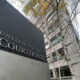 Exterior view of a courthouse sign reading 'United States Courthouse' beside a modern grey building with bare trees in autumn.