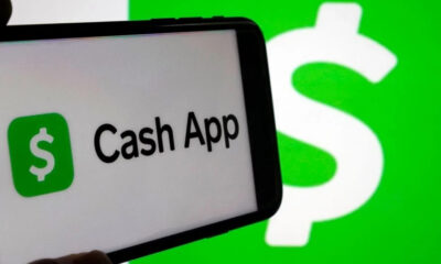 Phone screen showing the Cash App logo and text on a green background with a green dollar icon on the left.