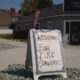 A-frame sign outside a church reads 'ASSISTANCE FOR FIRE SURVIVORS' offering help to fire victims.
