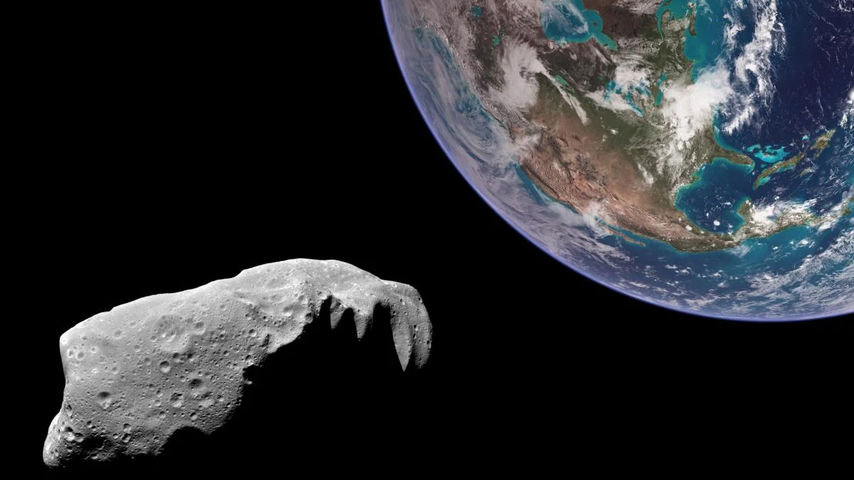 Cratered asteroid in foreground with Earth visible in the upper-right, space around.