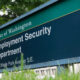 Sign for the State of Washington Employment Security Department, 212 Maple Park Avenue SE, outdoors in a grassy area with trees in the background.