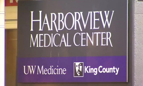Harborview Medical Center sign with UW Medicine and King County logos on a purple band