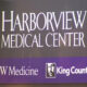 Harborview Medical Center sign with UW Medicine and King County logos on a purple band
