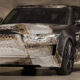 Front three-quarter view of a camouflaged Range Rover concept car with a brown/cream digital wrap in a studio setting.