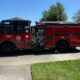 Red fire engine parked on a residential street with the number 74 on the door and equipment panels visible on the side.