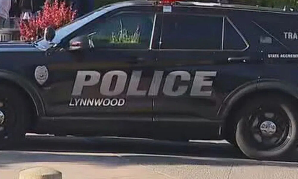 Black Lynnwood Police SUV side view with large POLICE lettering on door area and wheel visible