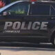 Black Lynnwood Police SUV side view with large POLICE lettering on door area and wheel visible