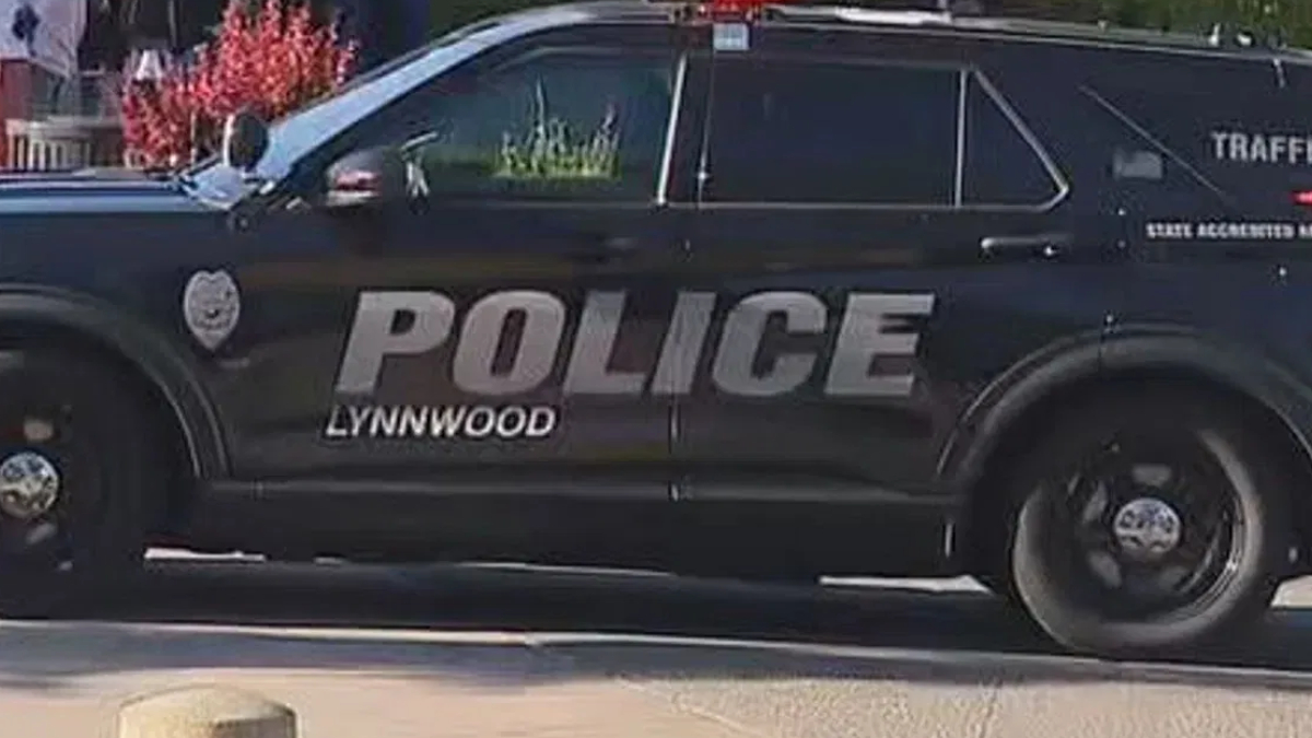 Black Lynnwood Police SUV side view with large POLICE lettering on door area and wheel visible