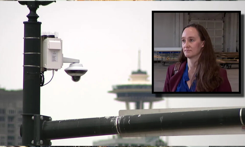 Surveillance camera on a street pole with a framed inset of a woman being interviewed outdoors.
