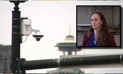 Surveillance camera on a street pole with a framed inset of a woman being interviewed outdoors.