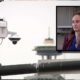 Surveillance camera on a street pole with a framed inset of a woman being interviewed outdoors.