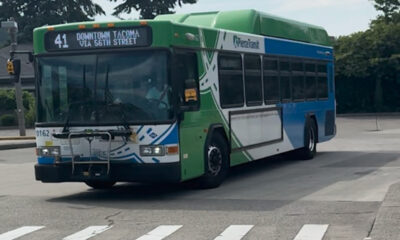 Public transit bus on a street, Route 41 to Downtown Tacoma via 56th Street, green and blue livery.