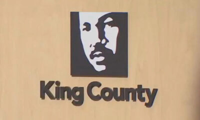 Logo: stylized black-and-white face in a square above the text 'King County' on a wood background.