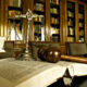 Open law book with a gavel and scales of justice on a dark table in a law library setting